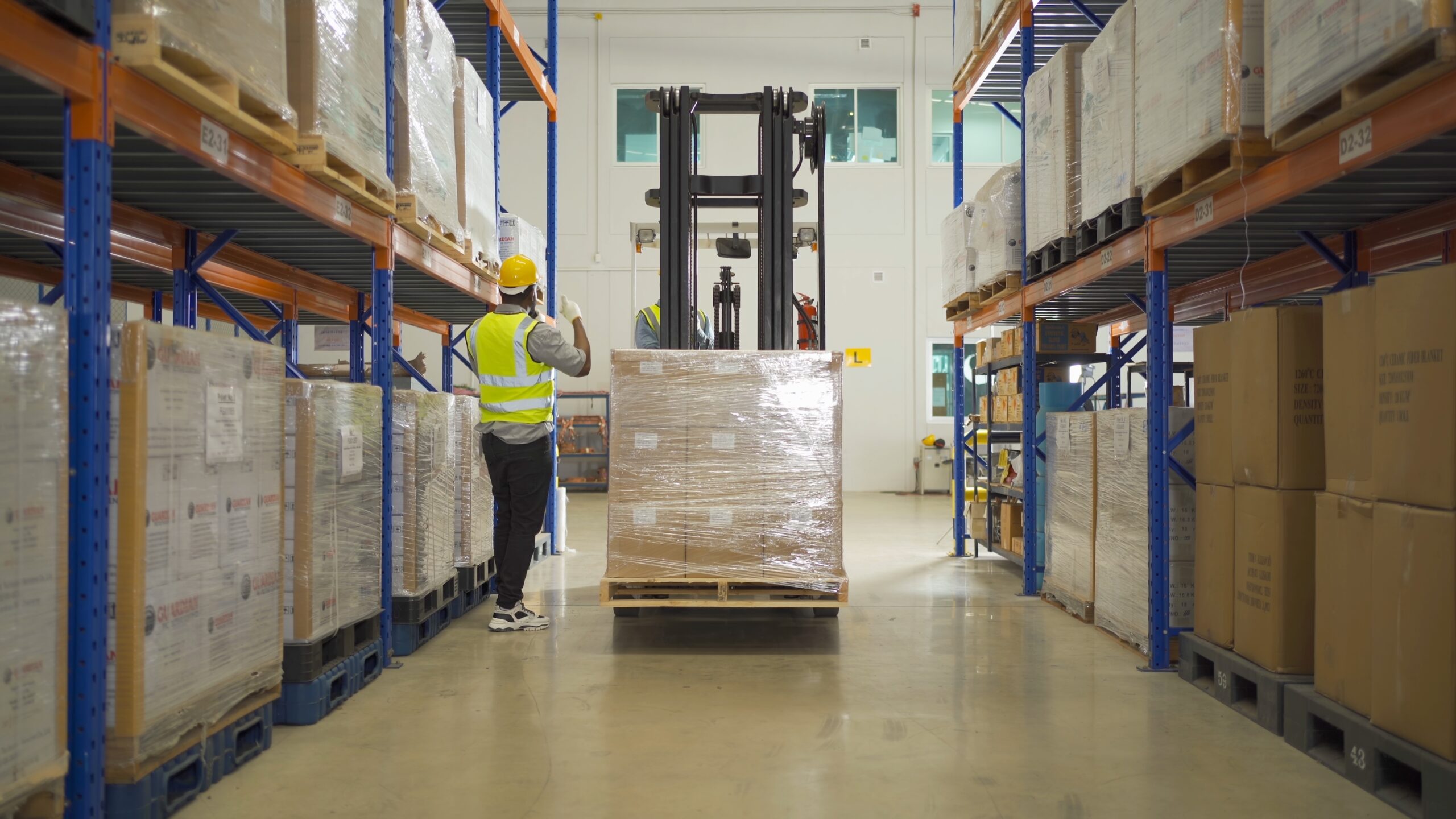 Teamwork,Of,Black,Workers,Working,In,Large,Warehouse,Store,Industry.rack